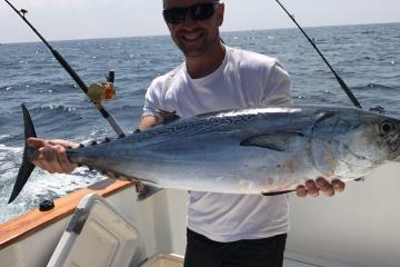 man holding fish he caught